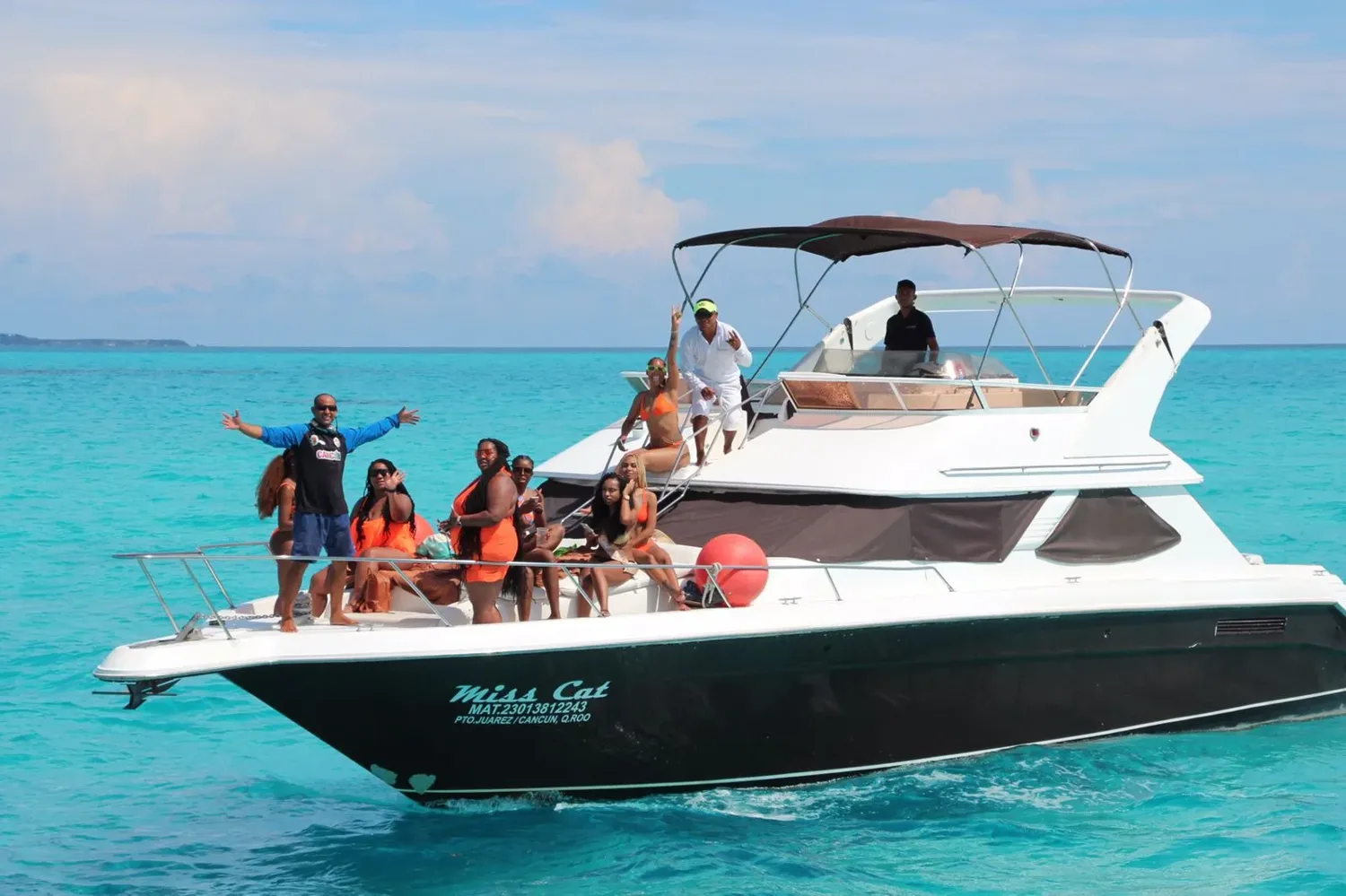 A group enjoying the bow of a yacht