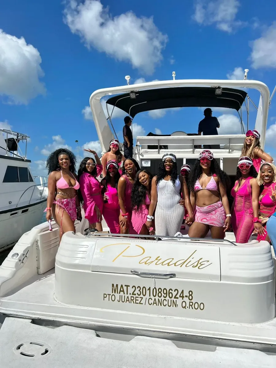 A group beside a yacht at the dock